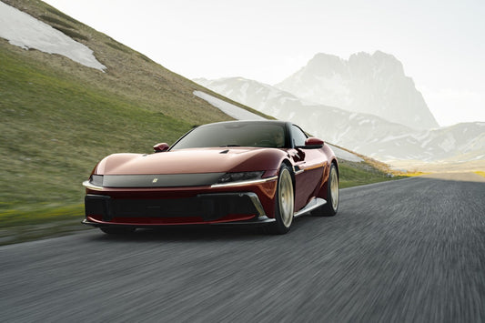 A front three-quarter view of the Ferrari 12Cilindri Manuale painted in Rosso Rubino, highlighting its sleek aerodynamics and iconic Maranello styling