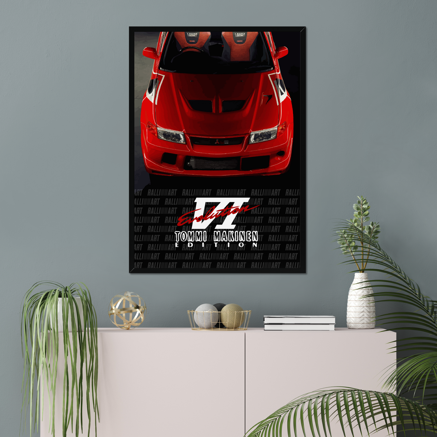 Red Evo VI black-framed print above a pink sideboard