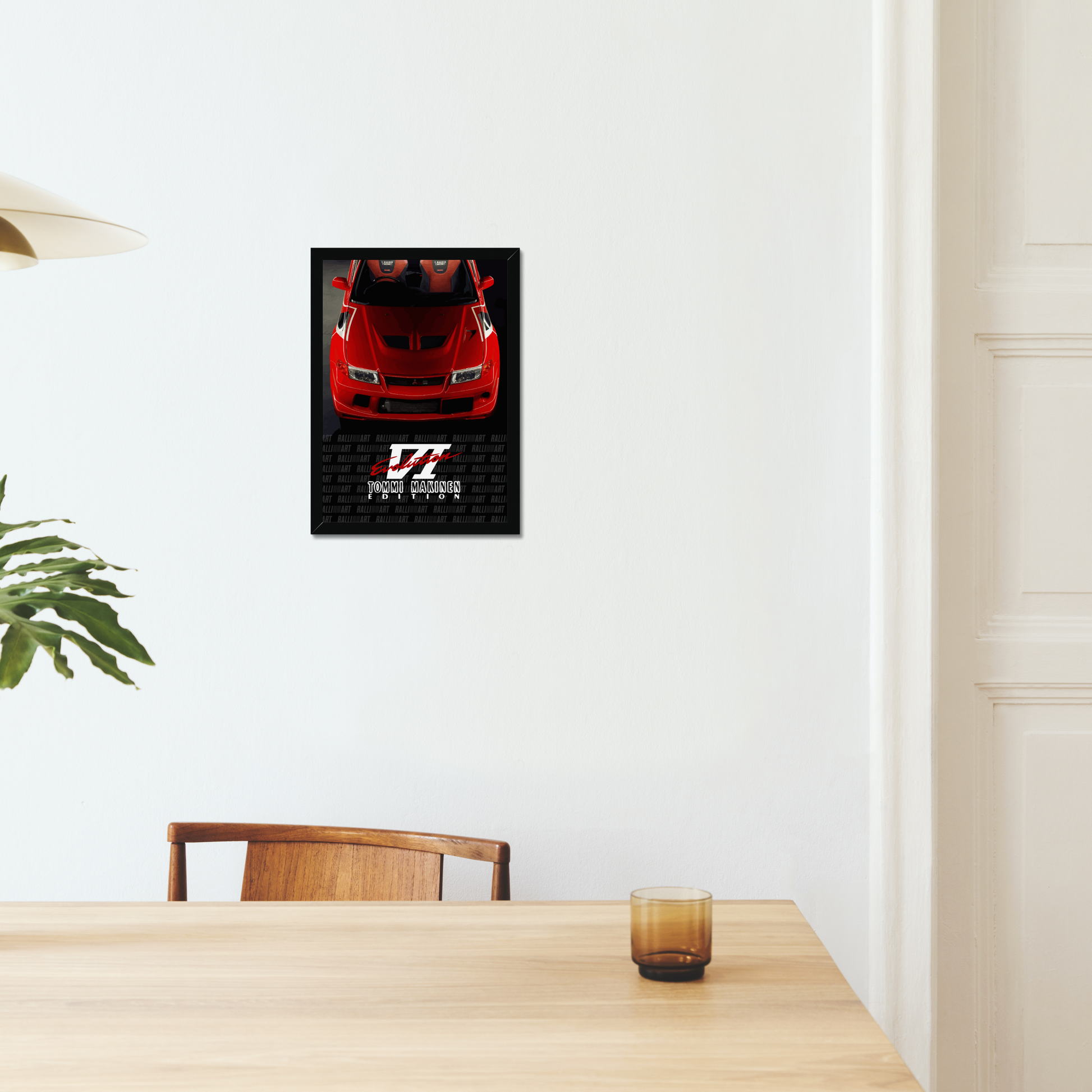 Red Evo VI black-framed print above a dining table