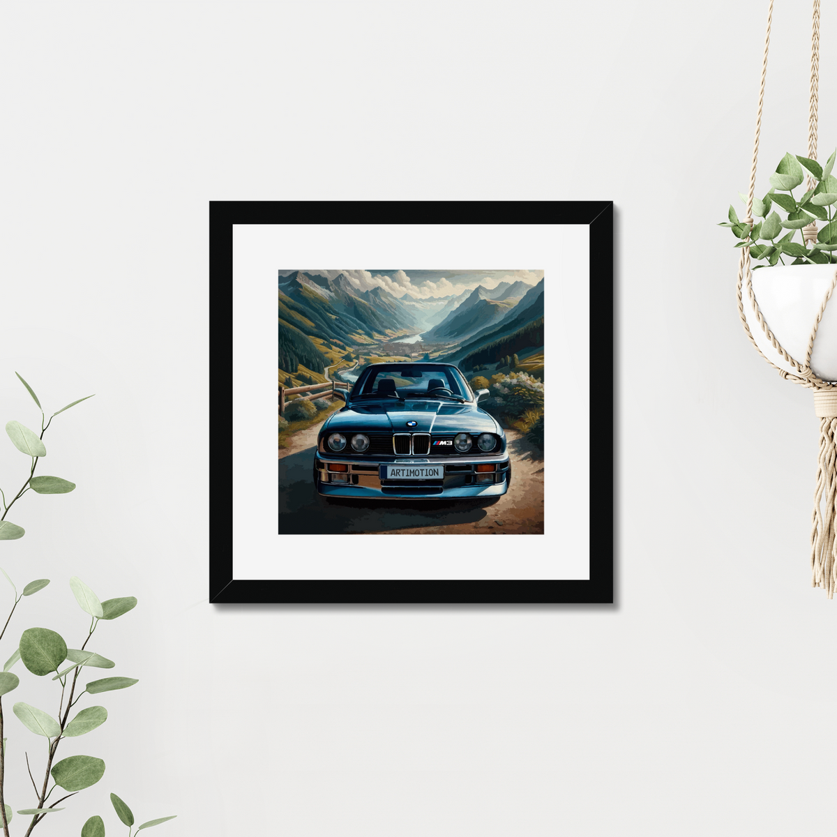 BMW E30 M3 mountain artwork beside hanging greenery