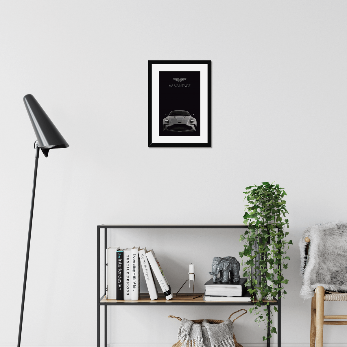 Black-framed V8 Vantage artwork above a modern shelf