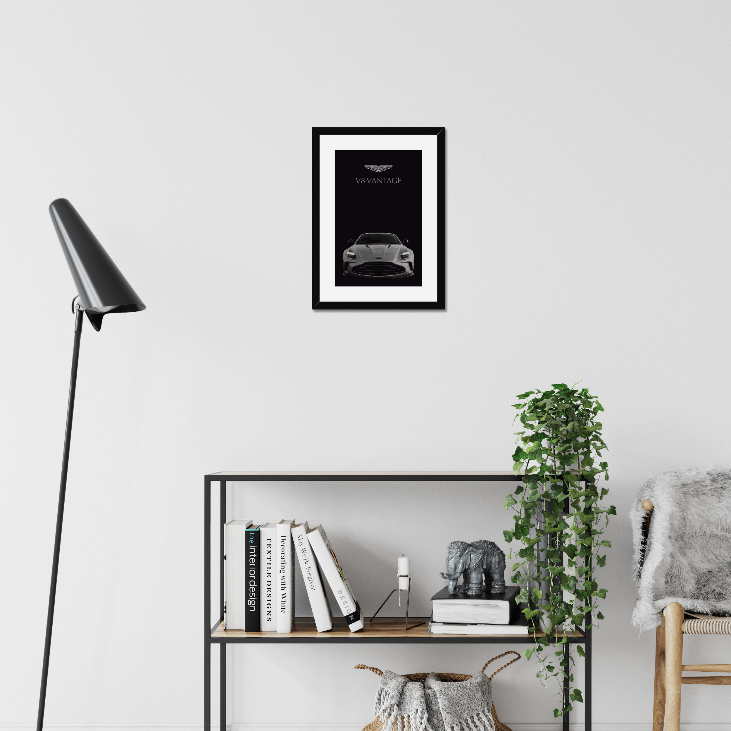 Black-framed V8 Vantage artwork above a modern shelf